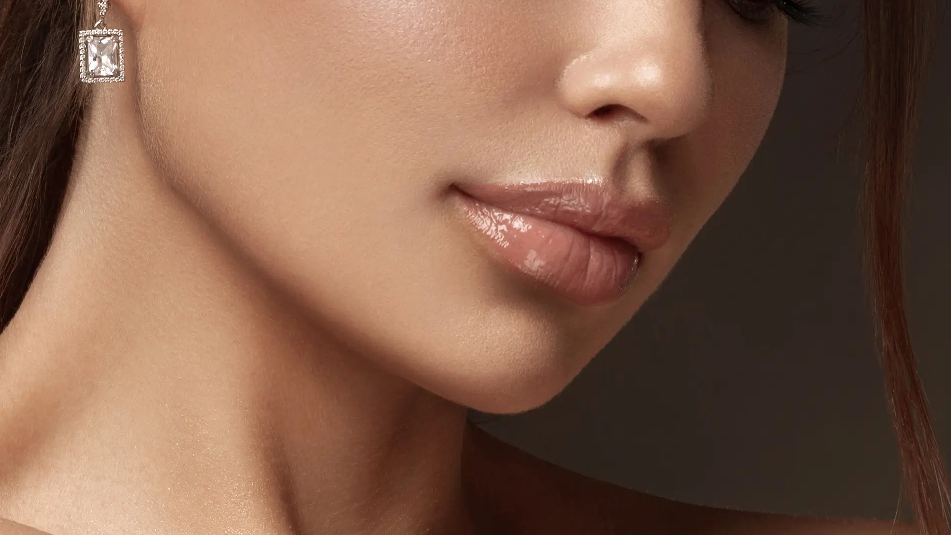 Beauty portrait of woman with natural makeup and glowing skin representing facial rejuvenation and cosmetic treatments by Dr. Sanaz Harirchian in Houston.