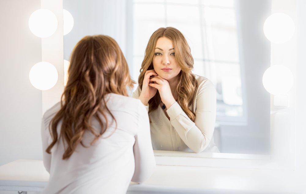 woman looking in mirror