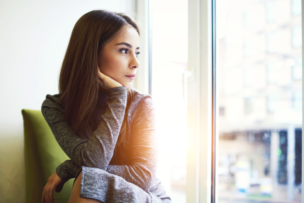 woman looking out window