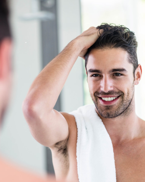 young man looking in the mirror