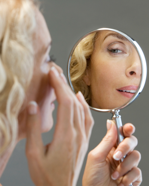 woman looking in mirror